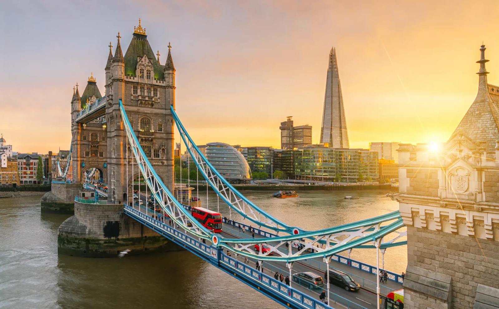 Tower Bridge over the River Thames at sunset, with the Shard behind